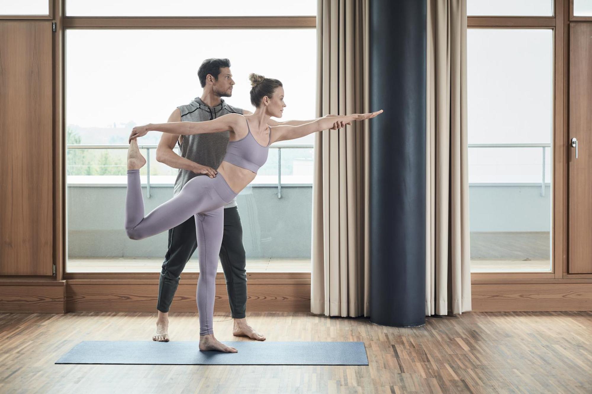 Falkensteiner Balance Resort Stegersbach - Adults Only Екстер'єр фото A woman practicing yoga with a personal trainer